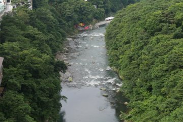 View from the front balcony, looking right down on the river. In the distance you can just make out the pulley system for lowering boats to the water.