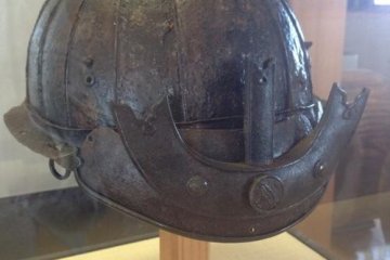 A samurai helmet discovered in the mud during excavations