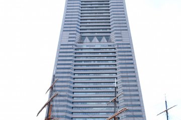 Relax on the grass looking up at the second tallest building in Japan!