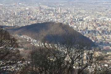 A smaller mountain near the city center called Maruyama is visible from the viewpoint.