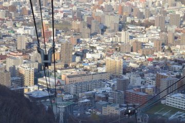 The descending cable car prepares to pass the ascending car. Passengers are asked to wave as they pass.