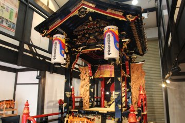 Large lacquer coach on display, pulled around town during festival season