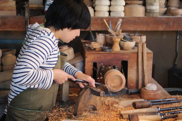 Creating her own wooden pot