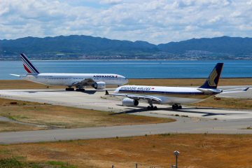 2 planes on the runway at Kansai Airport. Your journey in Japan might begin here.