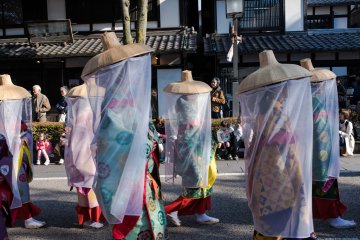 Young women wear traditional Uchikatsugi Veils, originally worn to protect noble identities