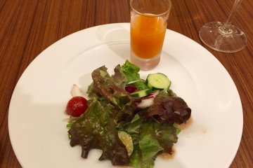 A freshly squeezed juice and salad
