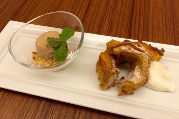 An ice-cream ball with cookie crumbles and an apple donut 