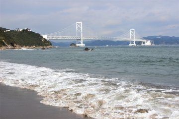 The Naruto Strait and the Onaruto Bridge from the shore. You can see the Aqua Eddy under the bridge.