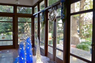 Big windows and a wide sunroom take in the nature that surrounds it
