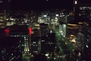 Looking north at night, with illuminated shapes that appear to be suspended over the city