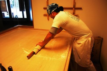 Rolling out the dough to make if flat and thin