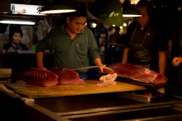 While fresh tuna is cut up with huge knives