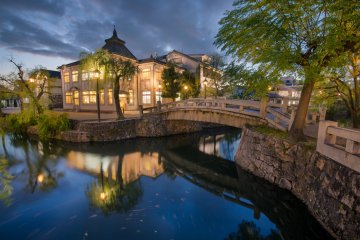 A nighttime view of the central bridge and canal