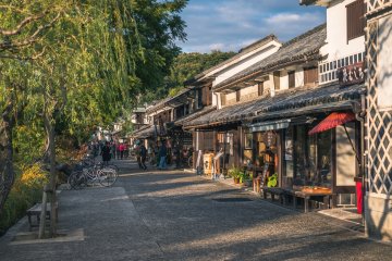 Shops in the quarter lit up by the setting sun