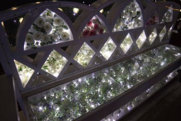A magical chair filled with flowers and lights