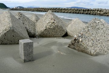 Engraved maker stone amongg the tumbled blocks of concrete