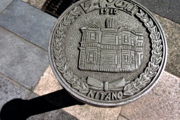 Various metal plaques with historical buildings on them could be seen along one street