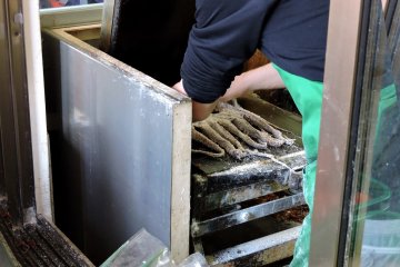 Man operating the toasted squid press