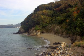 A small, secluded beach. You can see Shido Bay far in the distance to the left