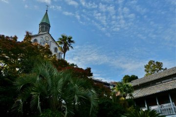 The church stands high up on a hill, under a deep blue sky