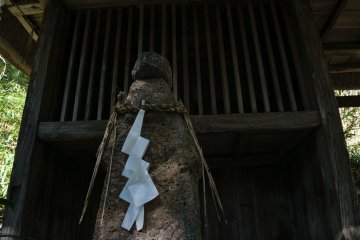 A stone statue in front of the tea hall
