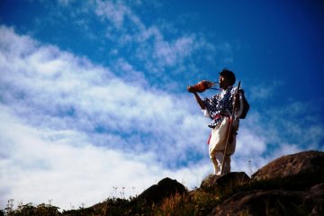 Masanori Naruse blowing his hora (conch shell) on top of Mount Gassan