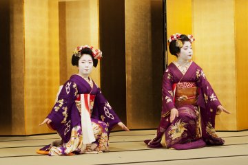 Maiko dancers in beautiful dresses perform the Kyo-mai dance
