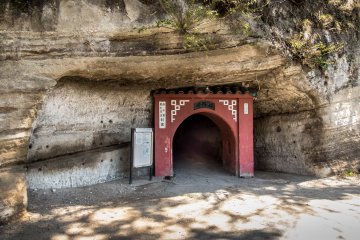   Opposite the train tracks is a small red tunnel