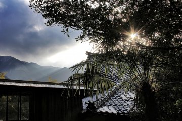 Weak winter sun illuminates the snowy mountains around Konpira-ji
