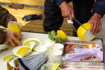 The entire group eats together, enjoying the fruit