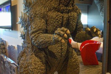 Human-sized Godzilla welcomes you