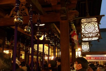 People wait in line for offerings and bell ringing