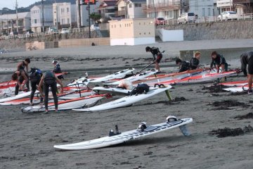 <p>Taking care of their windsurfing gear at the end of the day</p>
