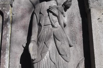 One of the carved figures on the big grave