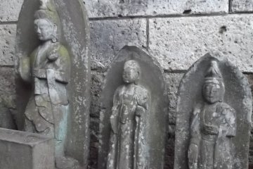 Behind the big statue