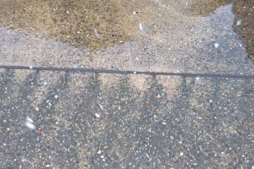 Many parking lots and sidewalk melt the snow with water in Akita
