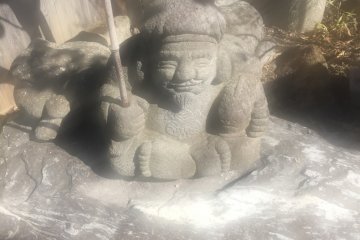 Statue of a man sitting while fishing