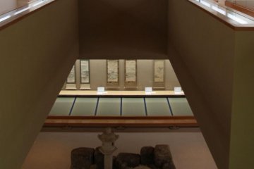 The view down from the second floor, afloat above the stone garden
