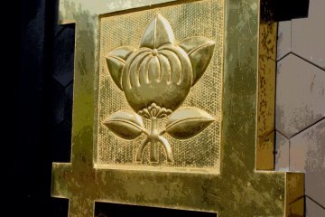 Close up on the golden emblem adorning the gate door