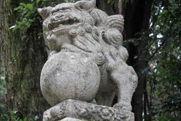 The first stone lion to greet you on the steps up