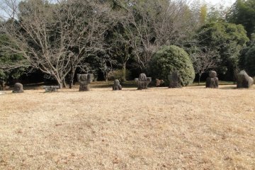Stone statues standing at the tomb's head