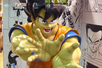 Une figurine taille réelle d'un héros de manga en vitrine de magasin