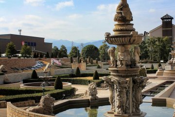 Beyond the ornate fountains you can see Mt. Ishizuchi in the distance