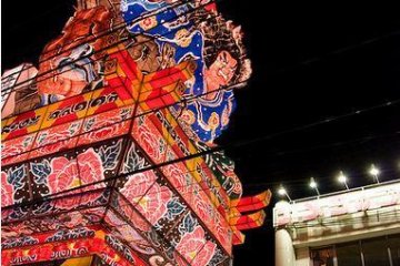 The floats are navigated down narrow streets lined with power lines.