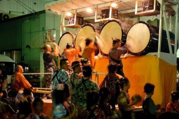 Pulled and pushed between the floats, drummers in traditional garb provide background music for the festival.