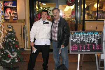 The author with a restaurateur near the fish market.