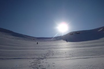 Sun setting behind crater rim.