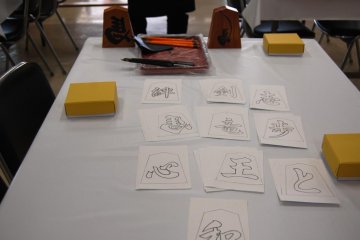 Getting ready: shogi piece, black ink and brushes and copies of kanji characters are the prerequists for shogi piece painting at Tendo Tower Shogimura in Tendo Town, home of Japanese chess