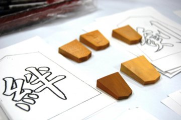 The shogi pieces for playing the game are small but decorative lucky charms can have any size - Tendo Town, home of Japanese chess