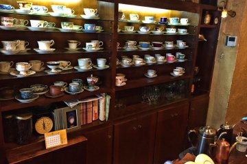 A cupboard full of exquisite cups and saucers